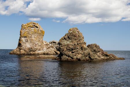 A beautiful stone outliers or rock formations near the coast of the Sea of Okhotsk. Cape Velikan, island Sakhalin, Russiaの写真素材