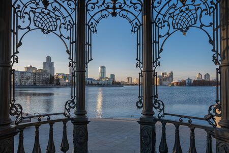 The city of Yekaterinburg, Russia. View of the Iset River and the embankment from the rotunda. City evening landscape.の写真素材