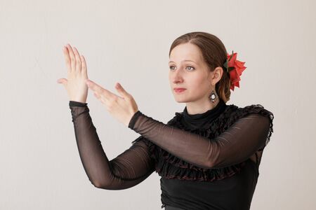 Beautiful young woman dancing flamenco in a black dress.の写真素材