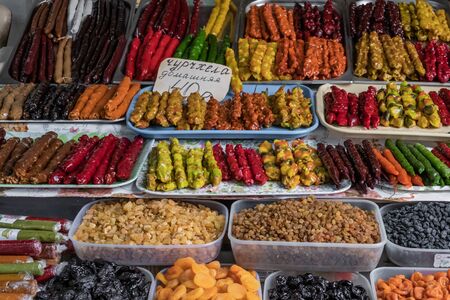 A counter with with dried fruits and local sweetness-churchkhela at the authentic bazaar of a resort town on the Black Sea coast of the Caucasus.の写真素材