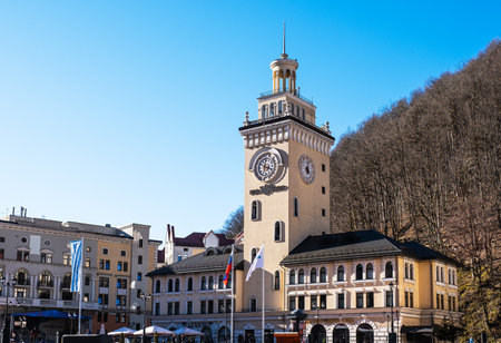Sochi, Russia - March 4, 2020: Ski resort Rosa Khutor. A view of town hall with clock on Rosa Square. Cityscapeのeditorial素材