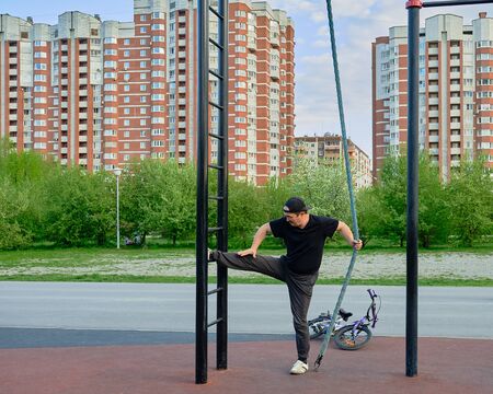 Senior asian man is training on the sports ground in the park against the background of the...