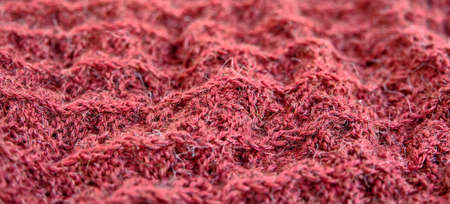 Hand-knitted wool coral fabric textureの写真素材