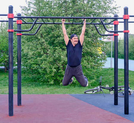 Happy senior asian man is training in the city parkの写真素材