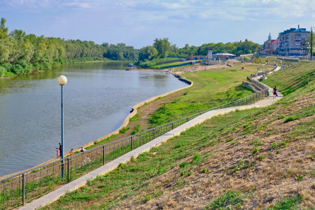Ishim, Russia - August 9, 2020: Cityscape. Embankment and beach on the Ishim river on a sunny summer dayのeditorial素材