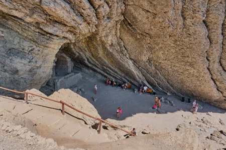 Sudak, Russia - September 14, 2020: Black Sea coast, Crimean peninsula. People are resting in a grotto carved out of the Koba-Kaya mountain by waves. A scenic natural attraction, grotto Golitsynのeditorial素材