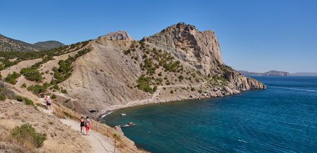 Sudak, Russia - September 14, 2020: Mountain landscape, Crimean peninsula. People walk along the tourist route Golitsyn Trail. Botanical reserve New World. Bannerのeditorial素材