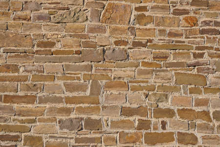 Texture of a stone brown wall of an ancient fortress as an abstract background.の写真素材