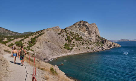 Mountain and sea landscape, Crimean peninsula. People walk along the tourist route Golitsyn Trail. Botanical reserve New World.の写真素材