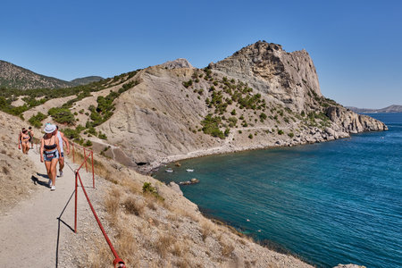 Sudak, Russia - September 14, 2020: Mountain landscape, Crimean peninsula. People walk along the tourist route Golitsyn Trail. Botanical reserve New World.のeditorial素材