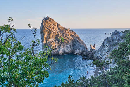 Rock Diva, the black sea coast near Yalta, Crimea. People walk on the suspension bridge, climb to the top, relax on the beachの写真素材