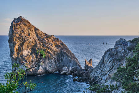 Rock Diva, the black sea coast near Yalta, Crimea. People walk on the suspension bridge, climb to the top, relax on the beachの写真素材
