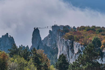 Beautiful mountain landscape of the southern Crimea. Ai Petri plateau. Suspension bridge between mountain battlements for extreme entertainment.の写真素材
