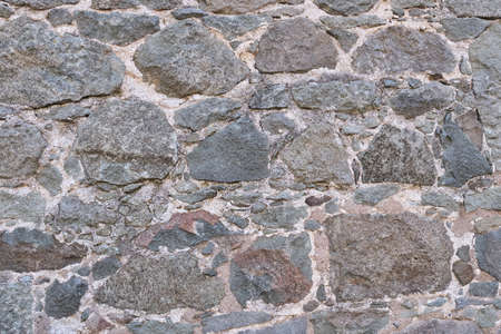 Texture of a stone wall built in the 19th century as a background