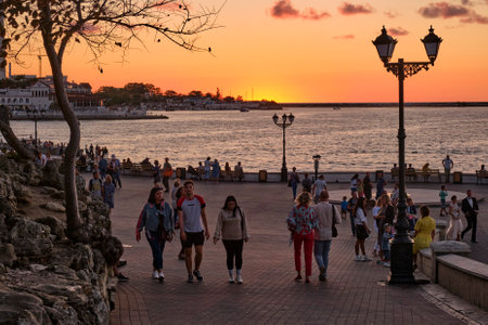 Sevastopol, Russia - September 27, 2020: People are walking along the seaside promenade at sunset.のeditorial素材