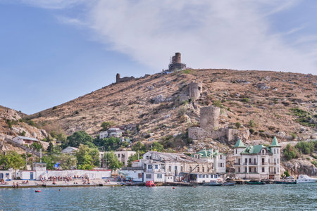 Sevastopol, Russia - October 6, 2020: View of the city beach Balaklava and Mount Krepostnaya with the ruins of the medieval Genoese fortress Chembalo, Crimean peninsula.のeditorial素材