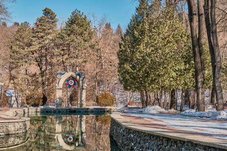 Winter or spring landscape. Beautiful national resort park of Kislovodsk, Russia. Mirror Pond and Glass Jet Pavilion.の写真素材