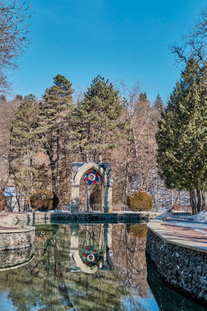 Winter or spring landscape. Beautiful national resort park of Kislovodsk, Russia. Mirror Pond and Glass Jet Pavilion.の写真素材
