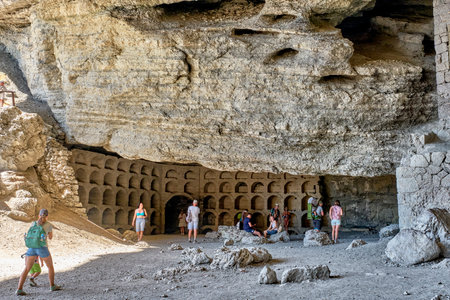Black Sea coast, Crimea. People are resting in a grotto carved out of the Koba-Kaya mountain by waves. A scenic natural attraction, grotto Golitsynのeditorial素材