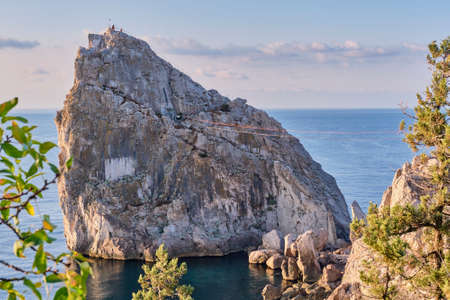 Rock Diva, the black sea coast near Yalta, Crimea. People walk on the suspension bridge, climb to the top, relax on the beachの写真素材
