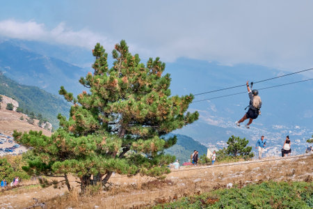 Southern Crimea People are walking along the high mountainous plateau Ai Petri Beautiful bold girl with long white hair comes down on trolleyのeditorial素材