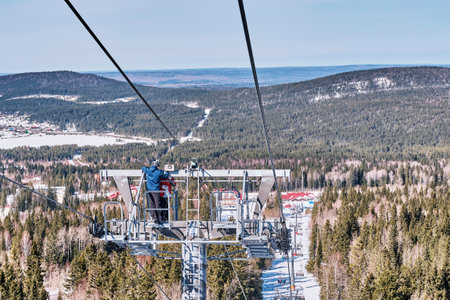 Signalmen install a warning system, loudspeakers on the support of the chairlift on the Mount Belaya or White. the Urals region, Russia.のeditorial素材