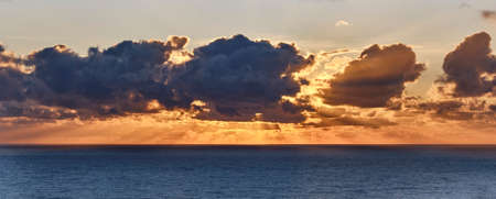 Dramatic sunset at sea. Cloudy landscape.