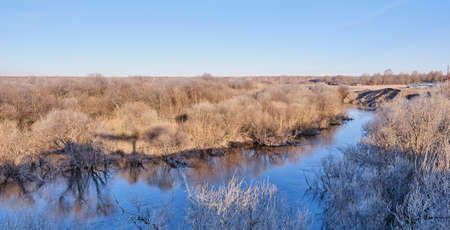 Siberian river Vagai in the early morning. The grass and bushes are covered with frost.の写真素材
