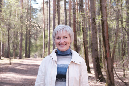 Portrait of a senior Caucasian woman in casual clothes smiling and looking into the cameraの写真素材