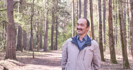 Half-length portrait of smiling senior Asian man.の写真素材
