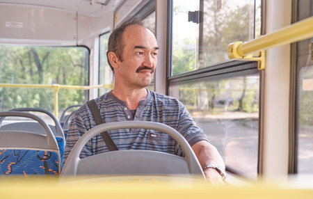 Portrait of senior Asian man in tram.の写真素材