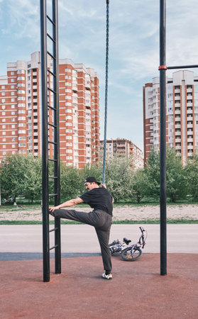 Senior asian man is training on the sports ground in the park against the background of the cityscape.の写真素材