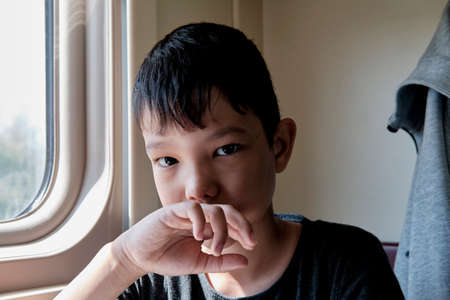 Portrait of young asian serious boy looking at cameraの写真素材