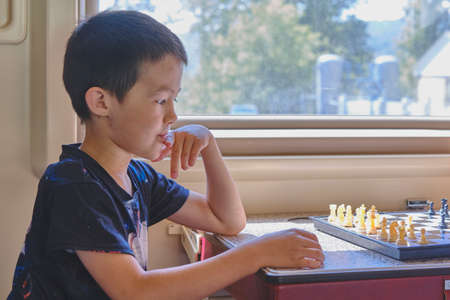 Young boy playing chessの写真素材