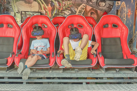 Two boys watching a scary video wearing virtual reality glasses.のeditorial素材