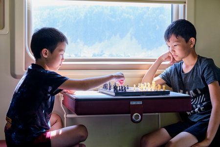 Young boys playing chessの写真素材