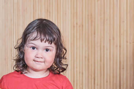 Close up home portrait of cute smiling asian little girlの写真素材