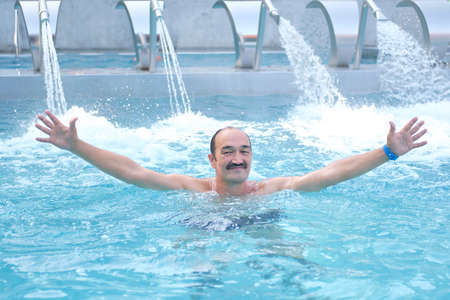 Mature asian man in outdoor thermal pool with hydromassage.の写真素材