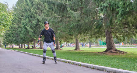 Active senior asian man is roller skating in park.の写真素材