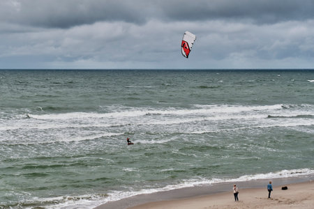 Beautiful seascape with kitesurfer riding waves.のeditorial素材