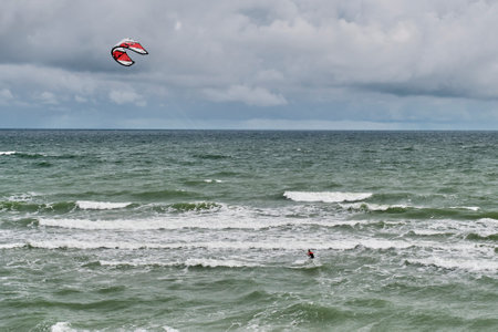 Beautiful seascape with kitesurfer riding waves.のeditorial素材