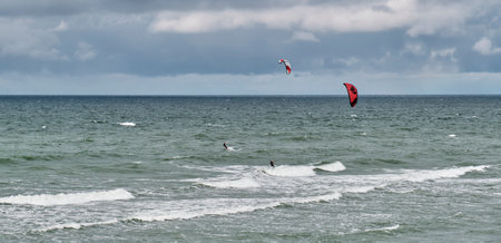 Beautiful seascape with two kitesurfers riding waves.のeditorial素材