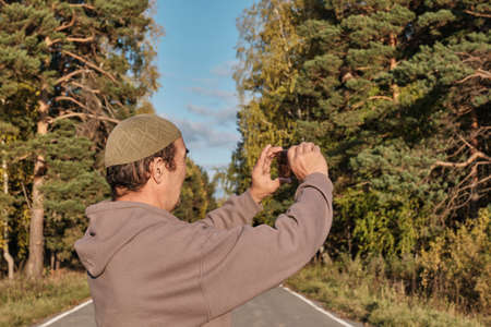 Senior Muslim asian man shooting video for his blog on mobile phoneの写真素材