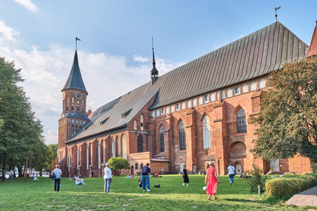 People walking near Cathedral, Brick Gothic style monument, symbol of city Kaliningrad. Russiaのeditorial素材