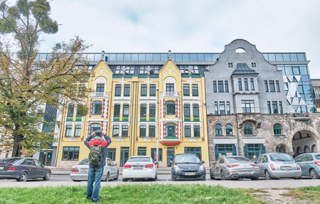 Male tourist taking photo of reconstructed historic building of Kreuz Pharmacy.のeditorial素材