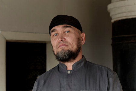 Portrait of serious senior asian muslim man wearing skullcap. looking at cameraの写真素材