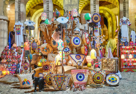 Bright colored Egyptian souvenirs for tourists . Applique straw bags, patterned dresses, oriental lamps.のeditorial素材
