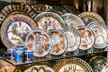 Souvenir ceramic plates with drawings based on history of Ancient Egypt on glass shelf. Travel conceptのeditorial素材