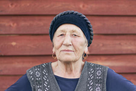 portrait of a asian senior woman in a traditional clothes living in a Siberian village, Russiaの写真素材