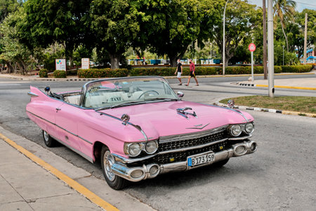 Pink retro cabriolet car taxi on street of resort town Varadero, Cuba.のeditorial素材